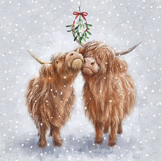 A festive illustration of two fluffy Highland cows standing in the snow and kissing under a hanging mistletoe with a red bow, on a light gray background with falling snow.